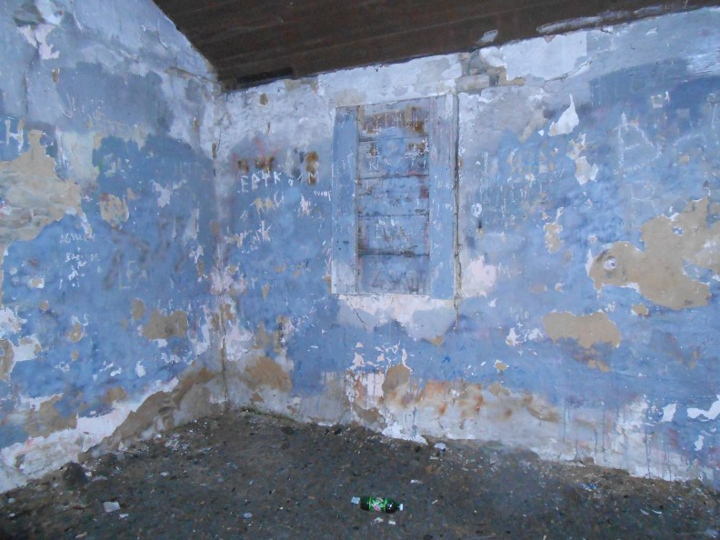 Back wall, boarded window